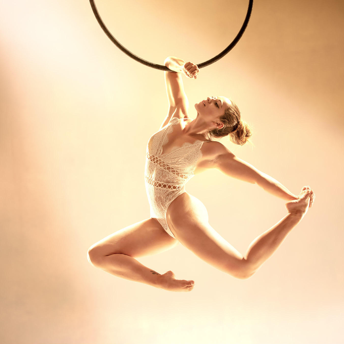 aerial hoop dancer blonde with golden background